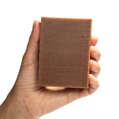 naked Backbone cinnamon essential oil organic bar soap from ground Soap in hand.
